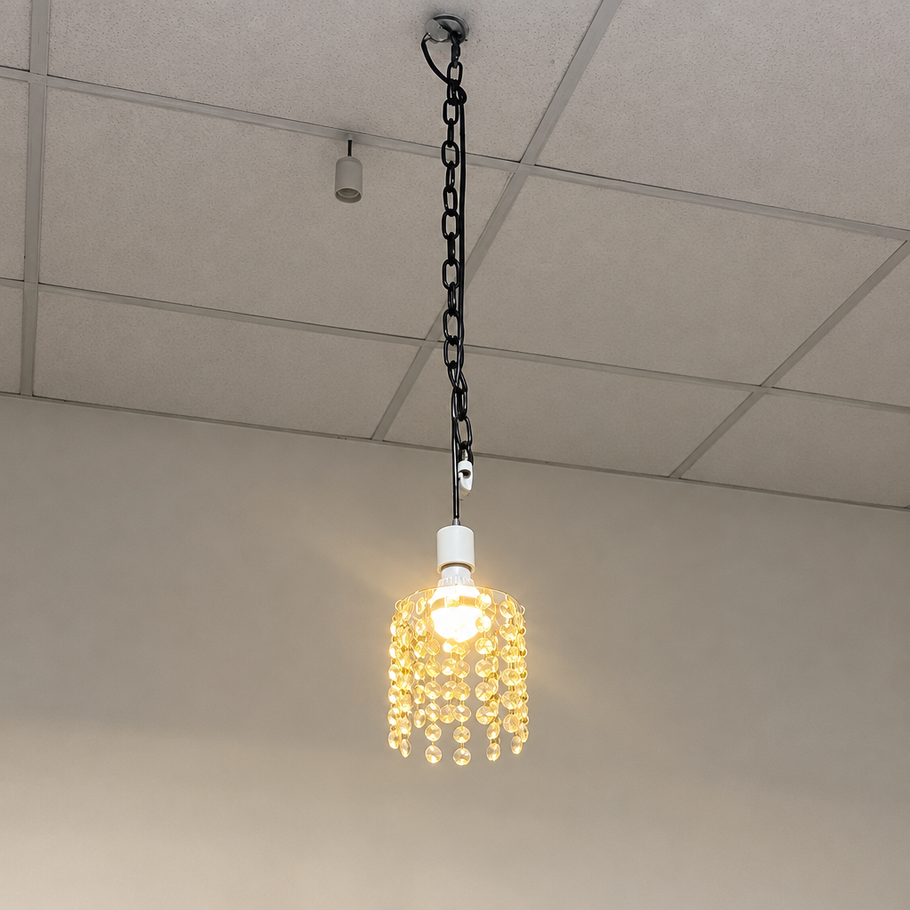 Compact illuminated crystal chandelier bulb shown in an installation setting